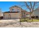 Inviting two-story home featuring a three-car garage and a charming front porch, perfect for Gathering living at 5126 S Malaya Way, Centennial, CO 80015