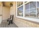 Charming front porch featuring a wooden bench, ample sunlight, and brick accents at 5126 S Malaya Way, Centennial, CO 80015