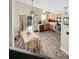 Bright kitchen and dining area with modern appliances, stylish wood floors, and a walkout to outdoor patio at 5126 S Malaya Way, Centennial, CO 80015