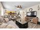Open-concept living room with a ceiling fan and a view of the kitchen and staircase at 5126 S Malaya Way, Centennial, CO 80015
