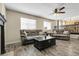 Spacious living room with wood-style flooring, plush couches, and abundant natural light at 5126 S Malaya Way, Centennial, CO 80015