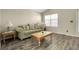 Inviting living room featuring modern flooring, a comfortable sofa, and stylish decor at 5126 S Malaya Way, Centennial, CO 80015