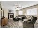 Inviting living room featuring a cozy fireplace, ceiling fan, and comfortable seating, perfect for relaxation at 5126 S Malaya Way, Centennial, CO 80015