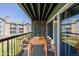 Spacious balcony featuring a wood table with cushioned chairs overlooking green space at 8843 Colorado Blvd # 208, Thornton, CO 80229