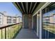 View of the condo balcony with stone accent wall and outdoor storage area at 8843 Colorado Blvd # 208, Thornton, CO 80229