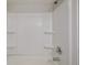 Close up of the shower featuring a white shower surround with built in shelves at 8843 Colorado Blvd # 208, Thornton, CO 80229