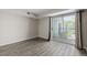 Bright bedroom features wood-look floors and sliding glass doors to the private balcony at 8843 Colorado Blvd # 208, Thornton, CO 80229