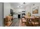 Stylish eat-in kitchen features white cabinets, stone countertops, and modern black appliances at 8843 Colorado Blvd # 208, Thornton, CO 80229