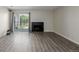 Open living room with access to outdoor patio, complete with a cozy fireplace, and modern flooring at 8843 Colorado Blvd # 208, Thornton, CO 80229