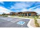 Stunning exterior of clubhouse with accessible parking on a bright day with ample foliage at 22980 E Del Norte Cir, Aurora, CO 80016