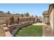 Multi-level backyard with retaining walls, artificial turf, and outdoor seating areas at 3981 Old Oaks St, Castle Rock, CO 80104