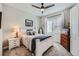 Cozy bedroom with carpet flooring, a comfortable bed, dresser, bedside table and natural light at 3981 Old Oaks St, Castle Rock, CO 80104