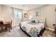 Cozy bedroom showcases a patterned bedspread, tufted headboard, and a tranquil ambiance at 3981 Old Oaks St, Castle Rock, CO 80104