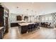 Gourmet kitchen with a large center island, stainless steel appliances, and an adjacent dining area at 3981 Old Oaks St, Castle Rock, CO 80104