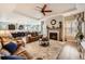 Open-concept living room features a cozy fireplace, tray ceiling, and seamless flow to the gourmet kitchen at 3981 Old Oaks St, Castle Rock, CO 80104