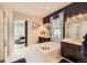 Spa-like bathroom featuring a soaking tub, dual vanities, modern fixtures, and access to the main bedroom at 3981 Old Oaks St, Castle Rock, CO 80104