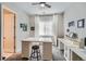 Bright office space features a ceiling fan, white desk setup, and natural light from the window at 3981 Old Oaks St, Castle Rock, CO 80104