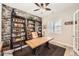 Stylish office with a brick accent wall, custom shelving, and a spacious desk area for productivity at 3981 Old Oaks St, Castle Rock, CO 80104