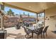 Inviting outdoor patio with a fireplace, grill, and dining set for comfortable entertaining at 3981 Old Oaks St, Castle Rock, CO 80104