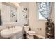 Stylish powder room featuring a pedestal sink, decorative shelves, and elegant finishes for a touch of sophistication at 3981 Old Oaks St, Castle Rock, CO 80104