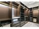 Spacious walk-in closet with custom shelving, drawers, and ample storage space for clothes and accessories at 3981 Old Oaks St, Castle Rock, CO 80104