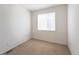 Neutral bedroom featuring carpet flooring, bright light, and ample closet space at 24664 E Louisiana Cir, Aurora, CO 80018
