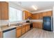 Bright kitchen featuring wood cabinets, stainless steel appliances, and hardwood floors at 24664 E Louisiana Cir, Aurora, CO 80018