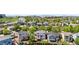 Stunning aerial view of a neighborhood with mature trees, well-maintained lawns, and a backdrop of scenic mountains at 9638 Marion Way, Thornton, CO 80229