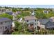 Backyard view featuring a two-story home, a wooden deck, and a well-maintained yard with trees and fencing at 9638 Marion Way, Thornton, CO 80229