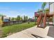 Backyard featuring concrete patio, stairs to deck, privacy fence, and green lawn, creating a serene outdoor space at 9638 Marion Way, Thornton, CO 80229