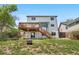 Spacious backyard featuring a large deck, covered patio, green lawn, and direct access to the home at 9638 Marion Way, Thornton, CO 80229