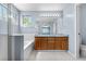 Bathroom with dual sinks, soaking tub, tiled floors, and a glass-enclosed shower at 9638 Marion Way, Thornton, CO 80229