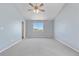 Spacious bedroom with neutral carpet, ceiling fan and a large window with pleasant natural light at 9638 Marion Way, Thornton, CO 80229