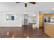 Bright and open living room with hardwood floors, stairs, and a view into the kitchen and entryway at 9638 Marion Way, Thornton, CO 80229
