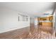 Bright open-concept living area with hardwood floors and a kitchen view at 9638 Marion Way, Thornton, CO 80229