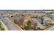 A wide aerial view shows the townhome complex near shops and a main street at 185 S Sable Blvd # T18, Aurora, CO 80012