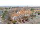 An aerial view showcases the townhome complex with mature trees and ample parking at 185 S Sable Blvd # T18, Aurora, CO 80012
