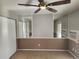 Inviting bedroom featuring a ceiling fan and mirrored walls, providing a relaxing atmosphere at 185 S Sable Blvd # T18, Aurora, CO 80012