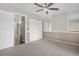 Bedroom featuring neutral carpet, closet, and ceiling fan; doorway adds to the spacious feel of the room at 185 S Sable Blvd # T18, Aurora, CO 80012
