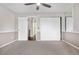 Bedroom featuring neutral carpet, closet, and ceiling fan; natural light from the doorway brightens the space at 185 S Sable Blvd # T18, Aurora, CO 80012