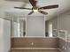 Comfortable bedroom featuring a ceiling fan and mirrored walls, with natural light at 185 S Sable Blvd # T18, Aurora, CO 80012