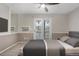 Cozy bedroom with a ceiling fan, mirrored wall, and sliding glass door to balcony at 185 S Sable Blvd # T18, Aurora, CO 80012