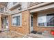 Brick townhouse entrance with a small rock garden and well-maintained walkway at 185 S Sable Blvd # T18, Aurora, CO 80012