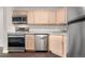Well-equipped kitchen featuring stainless steel appliances and light wood cabinetry at 185 S Sable Blvd # T18, Aurora, CO 80012