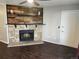 Open living room with wood floors and a charming stone fireplace with a wood accent wall above at 185 S Sable Blvd # T18, Aurora, CO 80012