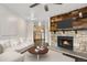 Inviting living room featuring a stone fireplace, sofa, and wood floors at 185 S Sable Blvd # T18, Aurora, CO 80012