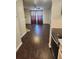 Inviting living room featuring dark wood-like floors, neutral walls, and a large window that floods the space with natural light at 185 S Sable Blvd # T18, Aurora, CO 80012