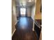 Inviting living room featuring dark wood-like floors, neutral walls, and a large window that floods the space with natural light at 185 S Sable Blvd # T18, Aurora, CO 80012