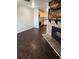 Cozy living space highlighting a rustic stone fireplace and decorative wood mantle, adjacent to a modern kitchen at 185 S Sable Blvd # T18, Aurora, CO 80012