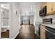 Open living space with natural light, wood floors, and access to bathroom, kitchen, and common area at 185 S Sable Blvd # T18, Aurora, CO 80012
